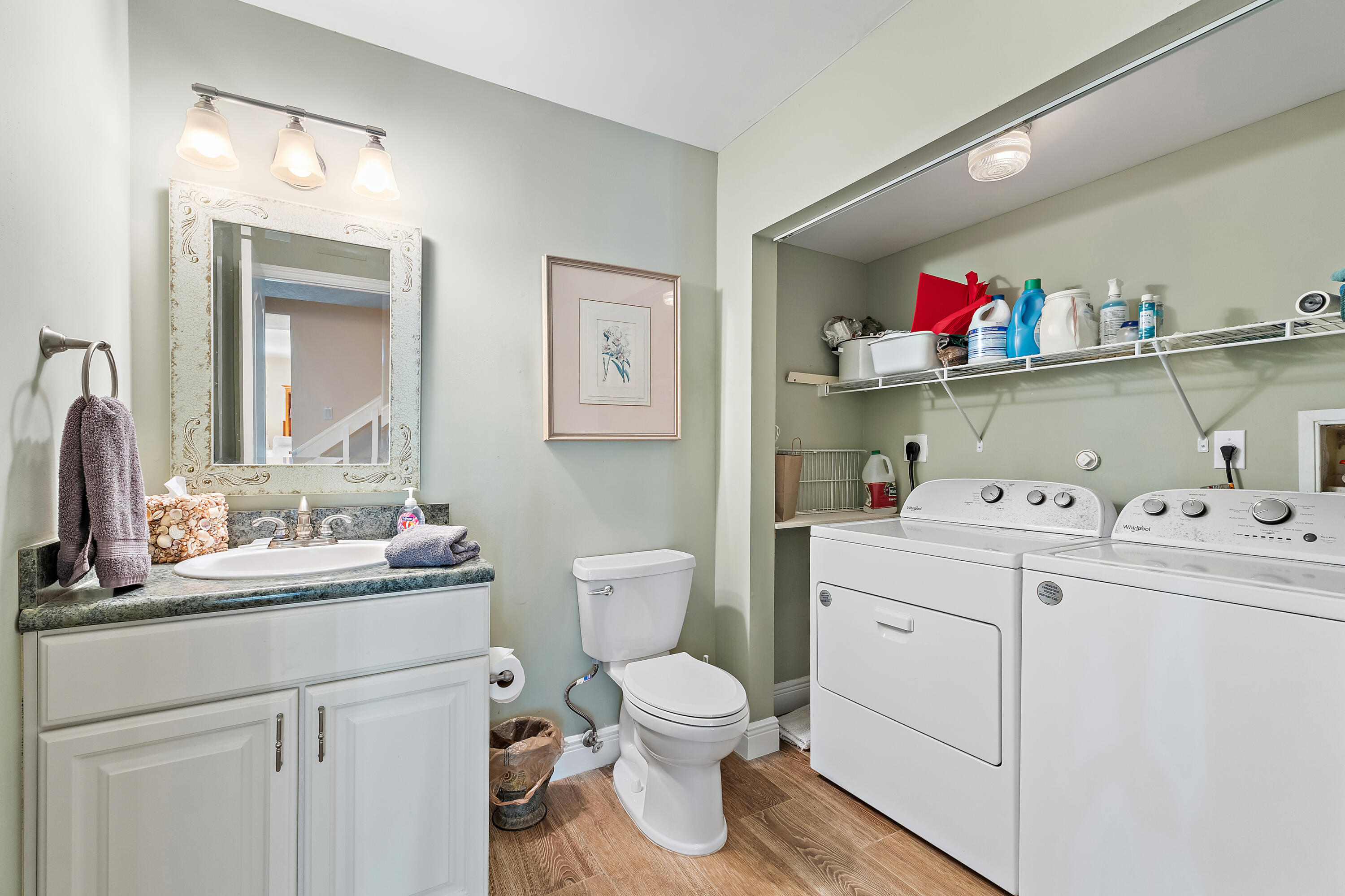 1420 Ocean Way, Unit 28D Jupiter, FL 33477 - Photo 16 of 33 a bathroom with a sink vanity mirror and toilet