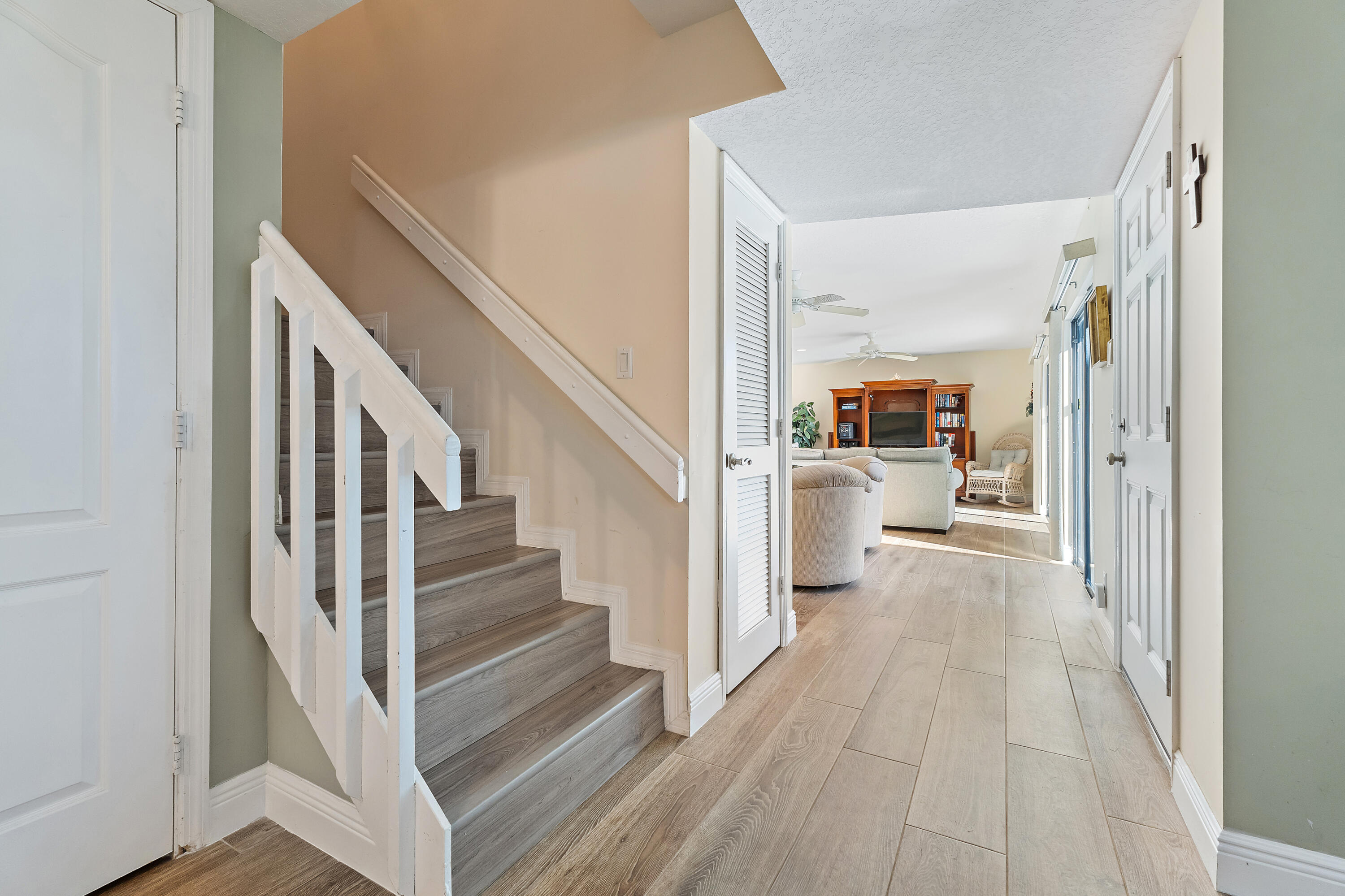 1420 Ocean Way, Unit 28D Jupiter, FL 33477 - Photo 17 of 33 a view of a living room with a wooden floor and a kitchen