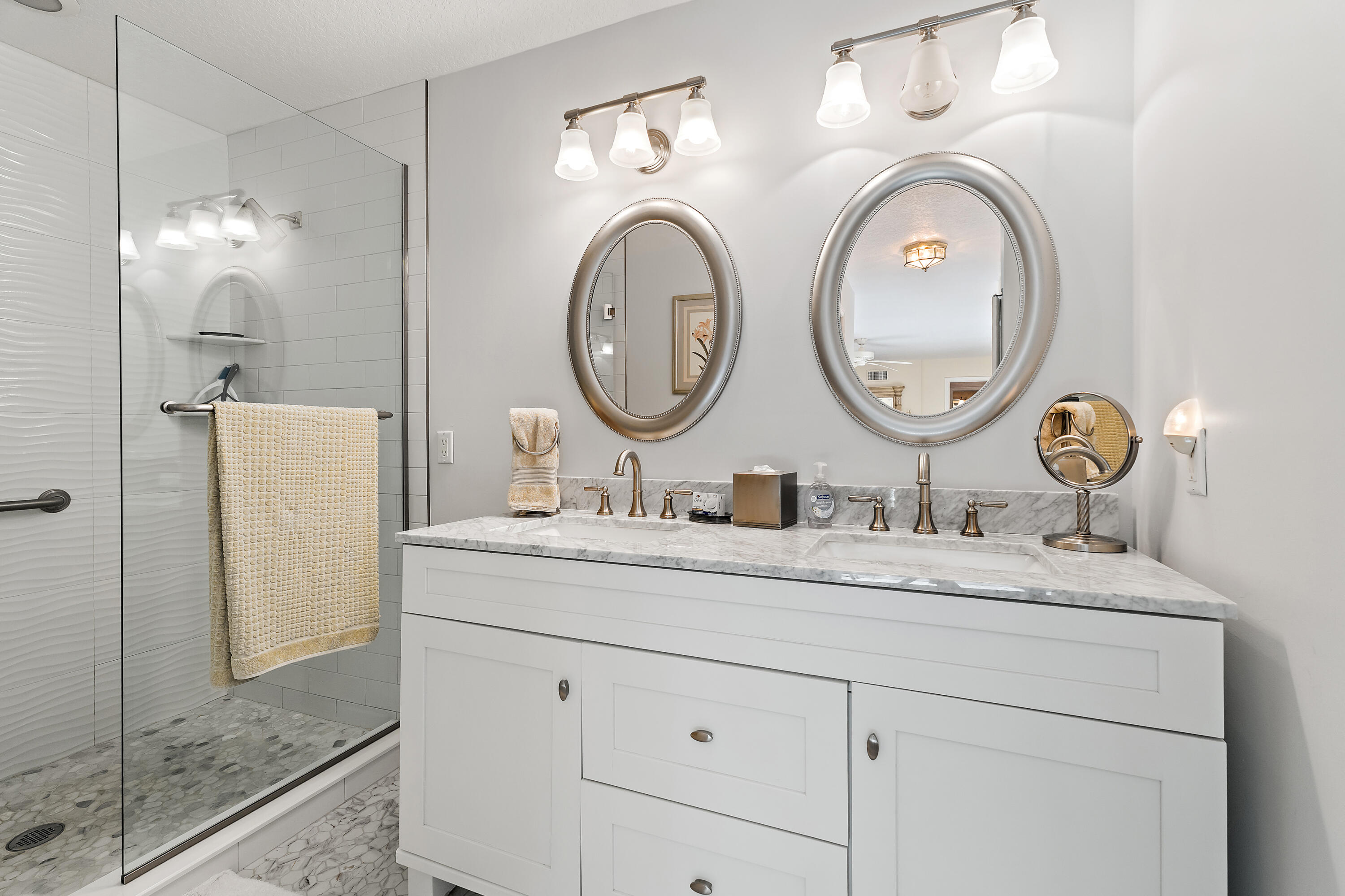 1420 Ocean Way, Unit 28D Jupiter, FL 33477 - Photo 21 of 33 a bathroom with a granite countertop double vanity sink and a mirror