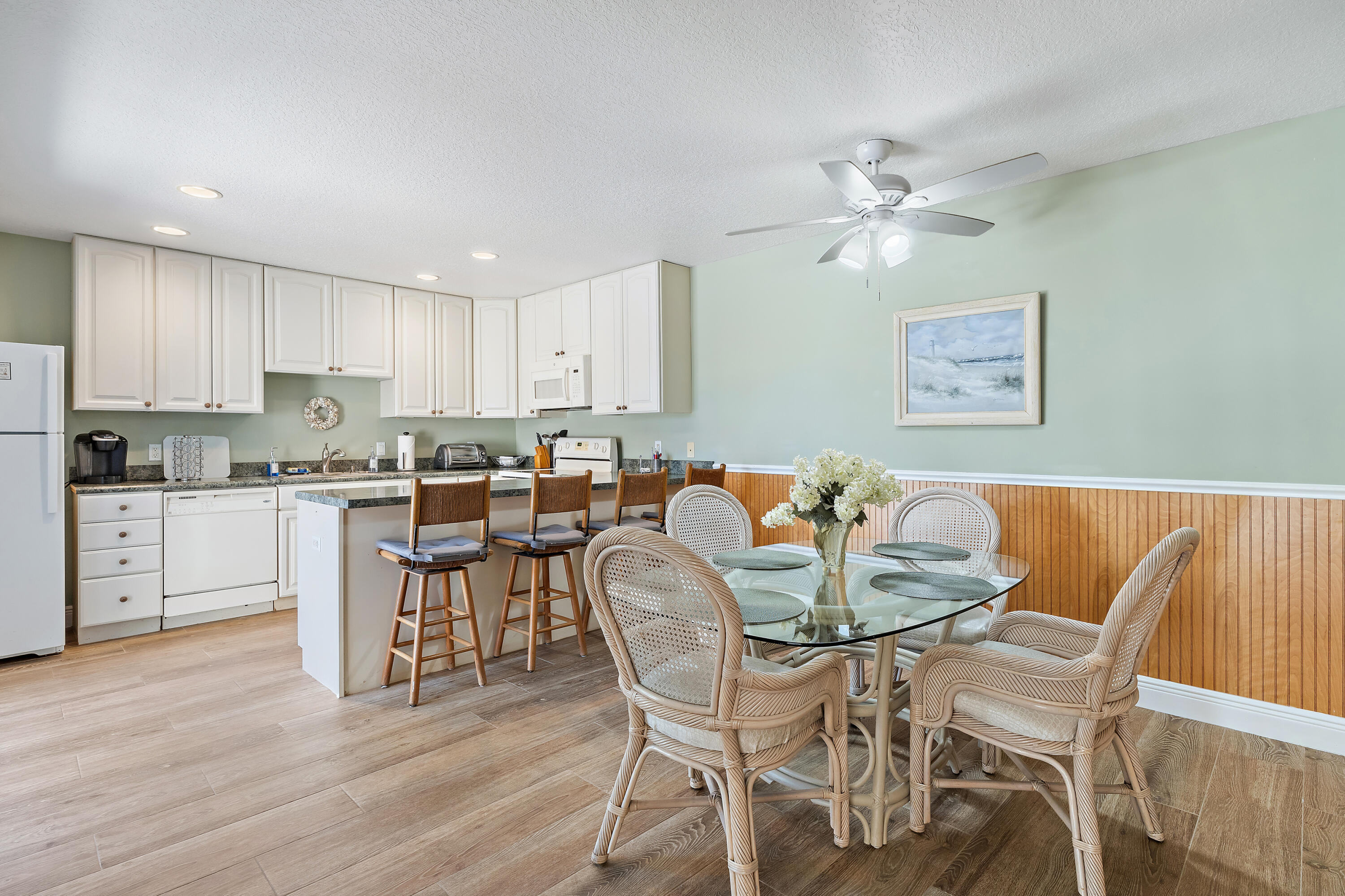 1420 Ocean Way, Unit 28D Jupiter, FL 33477 - Photo 8 of 33 a view of kitchen with cabinets and wooden floor