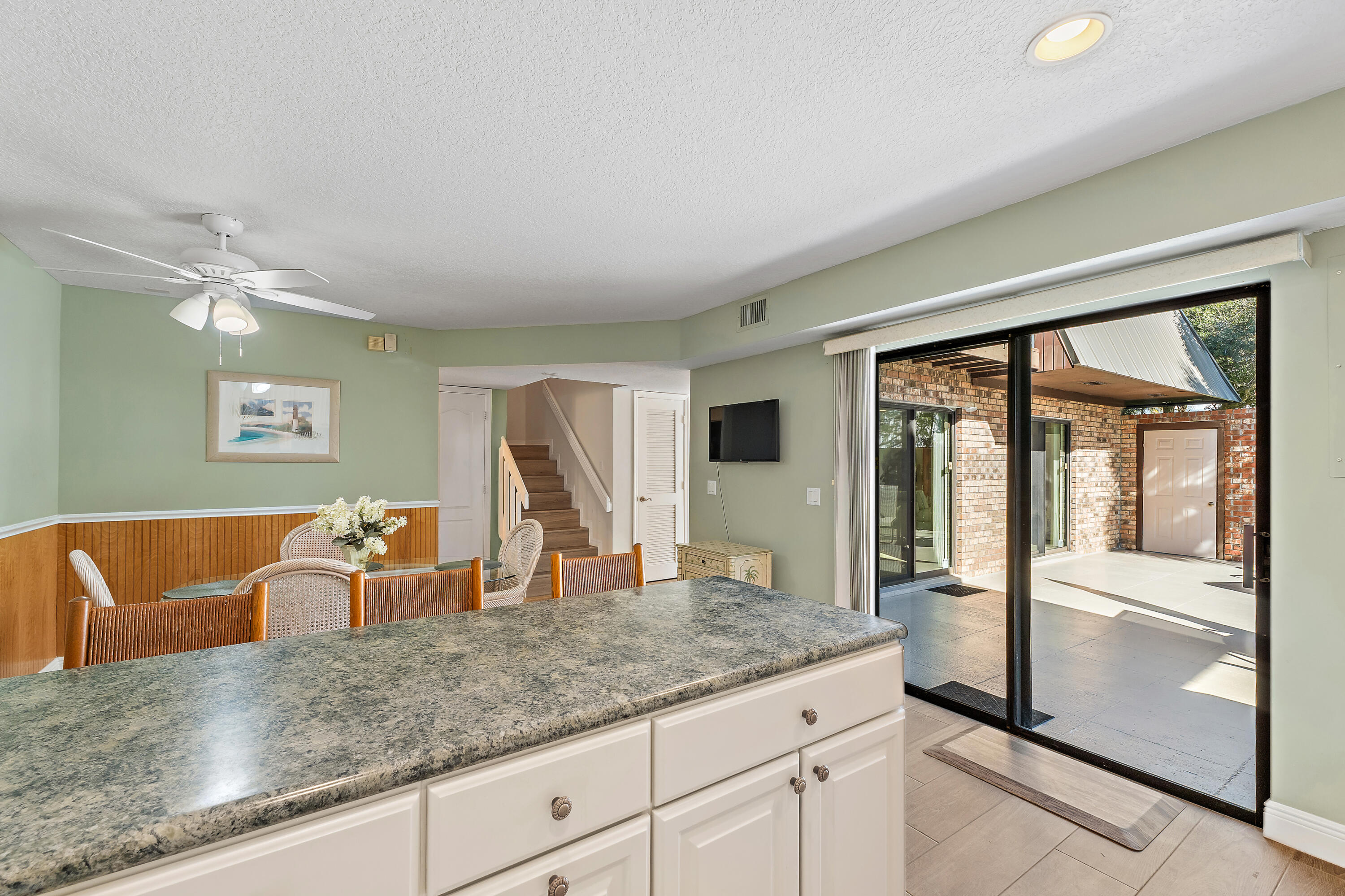 1420 Ocean Way, Unit 28D Jupiter, FL 33477 - Photo 9 of 33 a kitchen with granite countertop a sink and a refrigerator
