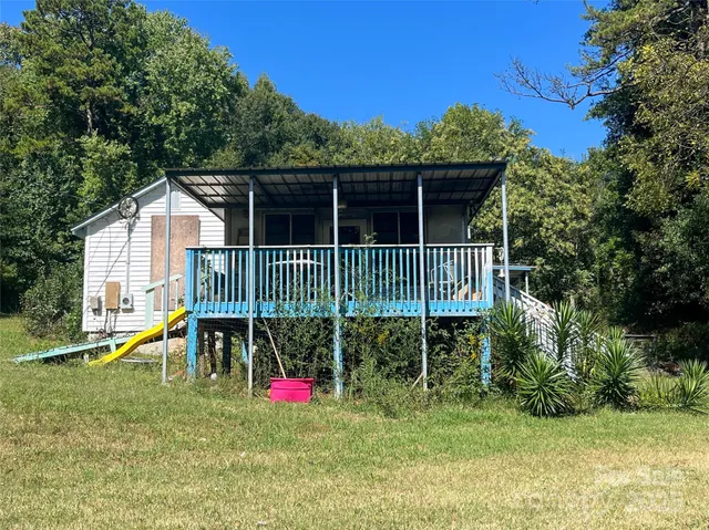 a view of a chair and table in the backyard of the house