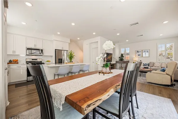 a dining room with furniture and wooden floor