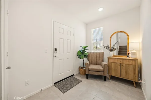 a kitchen with stainless steel appliances a refrigerator sink and white cabinets