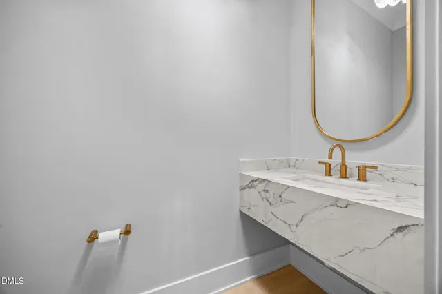 a view of an empty room with wooden floor and a ceiling fan