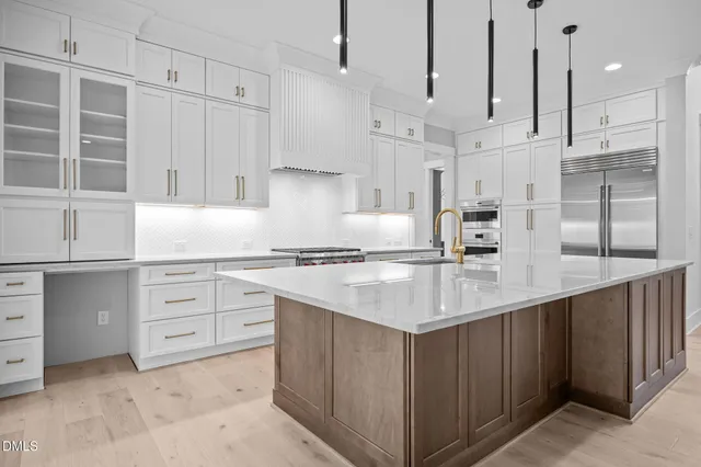 a kitchen with cabinets and stainless steel appliances