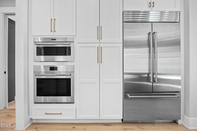 a kitchen with stainless steel appliances granite countertop a stove and a microwave