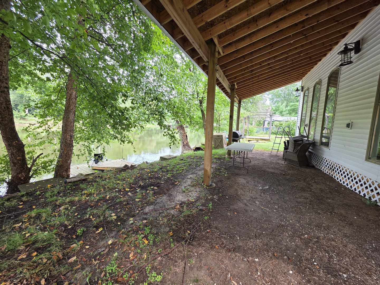 2709 North River Isle Road Momence, IL 60954 - Photo 3 of 23 a view of a backyard with large trees and wooden fence