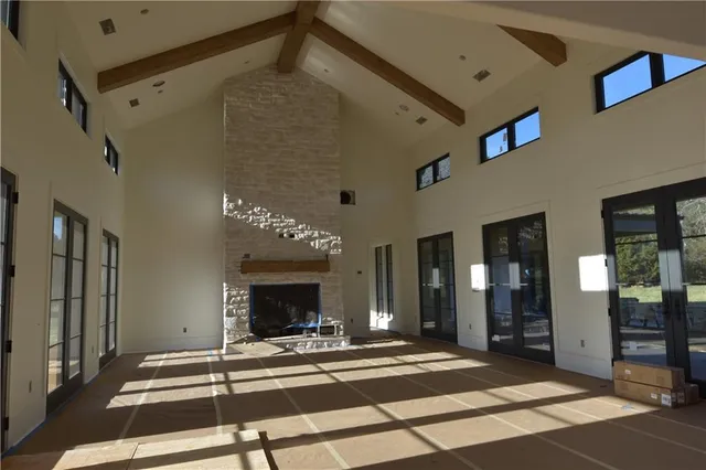 a view of a porch with furniture and floor to ceiling window