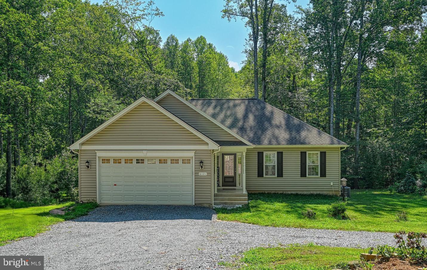 a view of a house with a backyard
