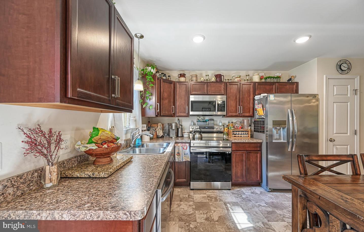 6121 Belmont Road Mineral, VA 23117 - Photo 14 of 32 a kitchen with stainless steel appliances granite countertop a sink stove and refrigerator