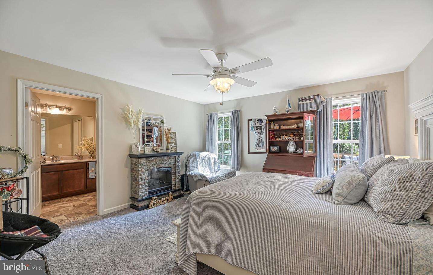 6121 Belmont Road Mineral, VA 23117 - Photo 18 of 32 a bedroom with a large bed and a chandelier