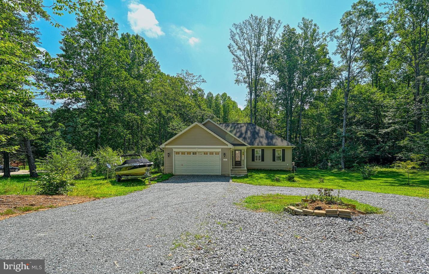 6121 Belmont Road Mineral, VA 23117 - Photo 2 of 32 a view of a house with a yard and large trees
