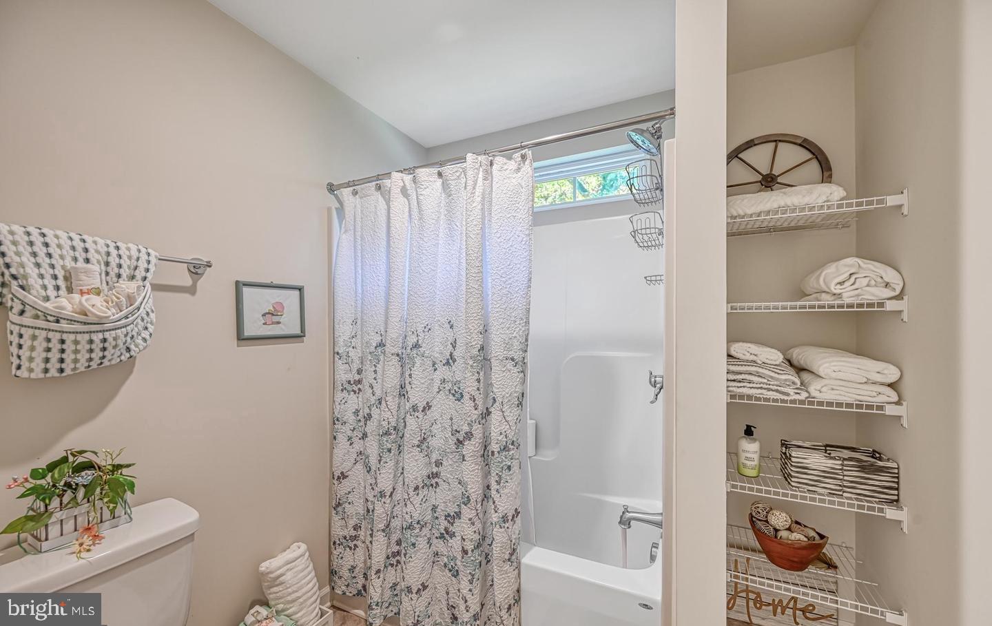 6121 Belmont Road Mineral, VA 23117 - Photo 21 of 32 a bathroom with a shower curtain and a window