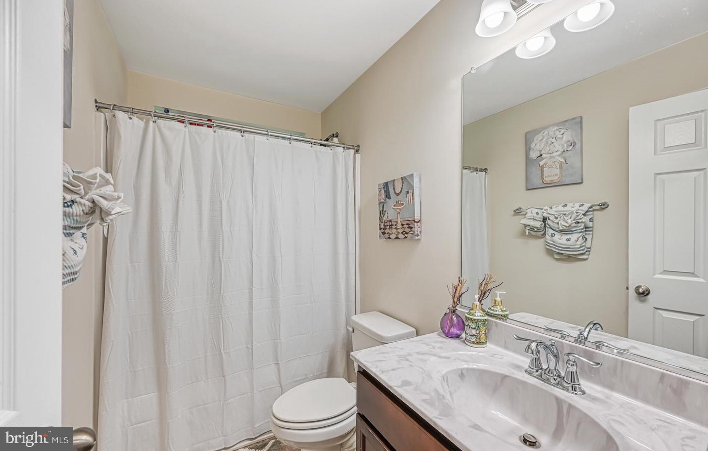6121 Belmont Road Mineral, VA 23117 - Photo 24 of 32 a bathroom with a granite countertop sink a toilet and a mirror