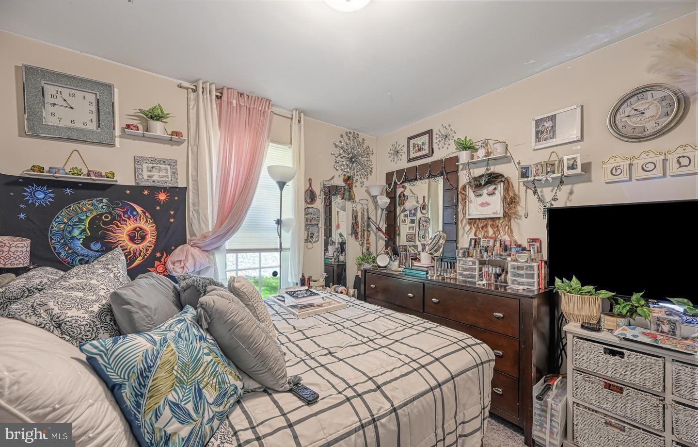 6121 Belmont Road Mineral, VA 23117 - Photo 25 of 32 a bedroom with a bed a flat screen tv and a large window