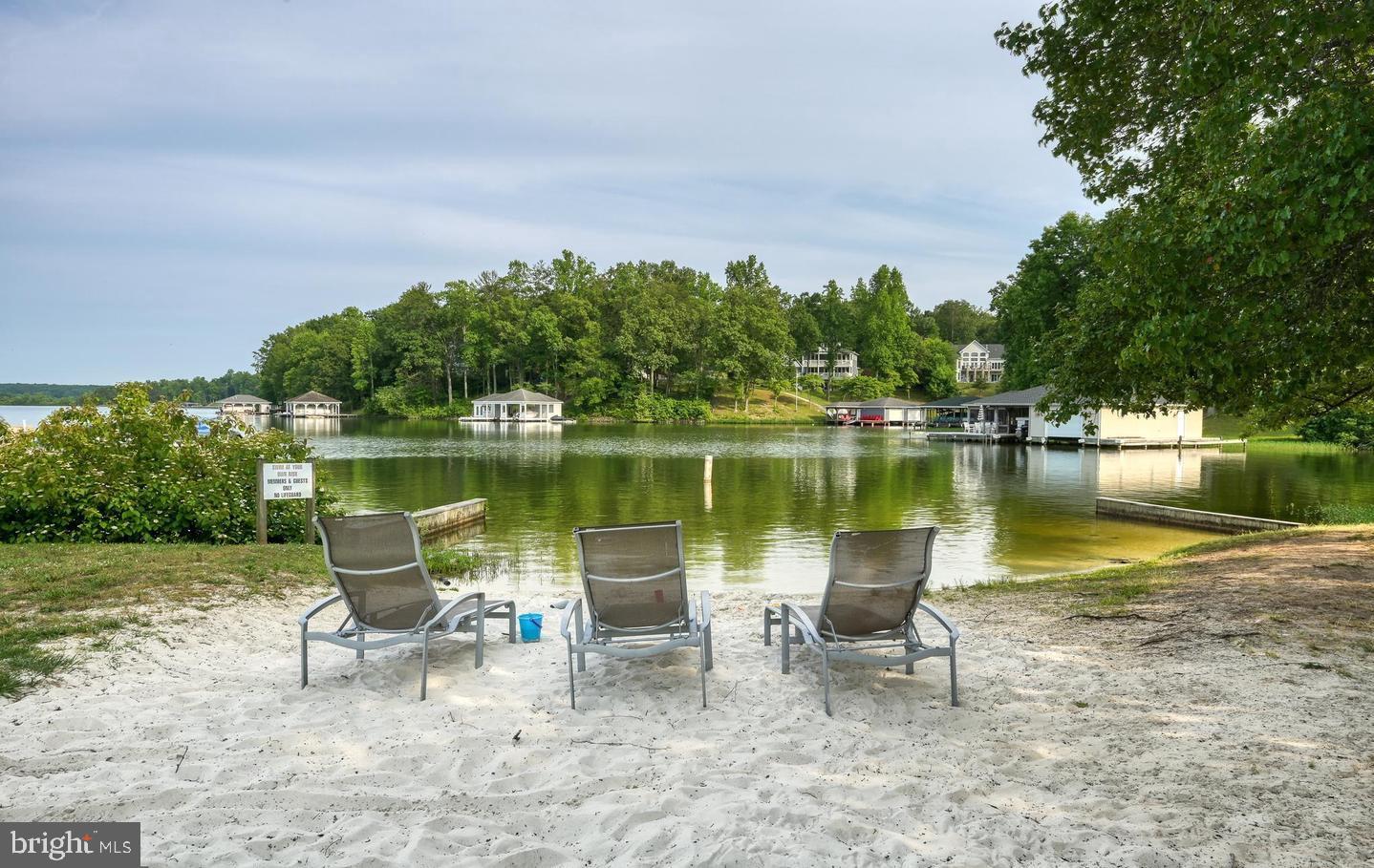 6121 Belmont Road Mineral, VA 23117 - Photo 28 of 32 a view of a lake with a table and chairs in the patio