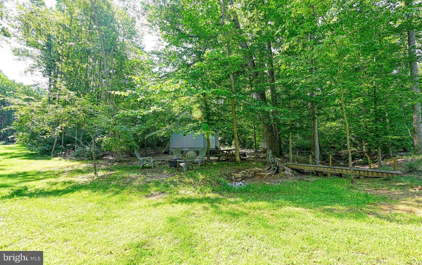 6121 Belmont Road Mineral, VA 23117 - Photo 6 of 32 a view of a backyard with table and chairs and wooden fence