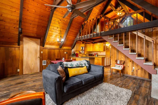 a living room with furniture and a floor to ceiling window