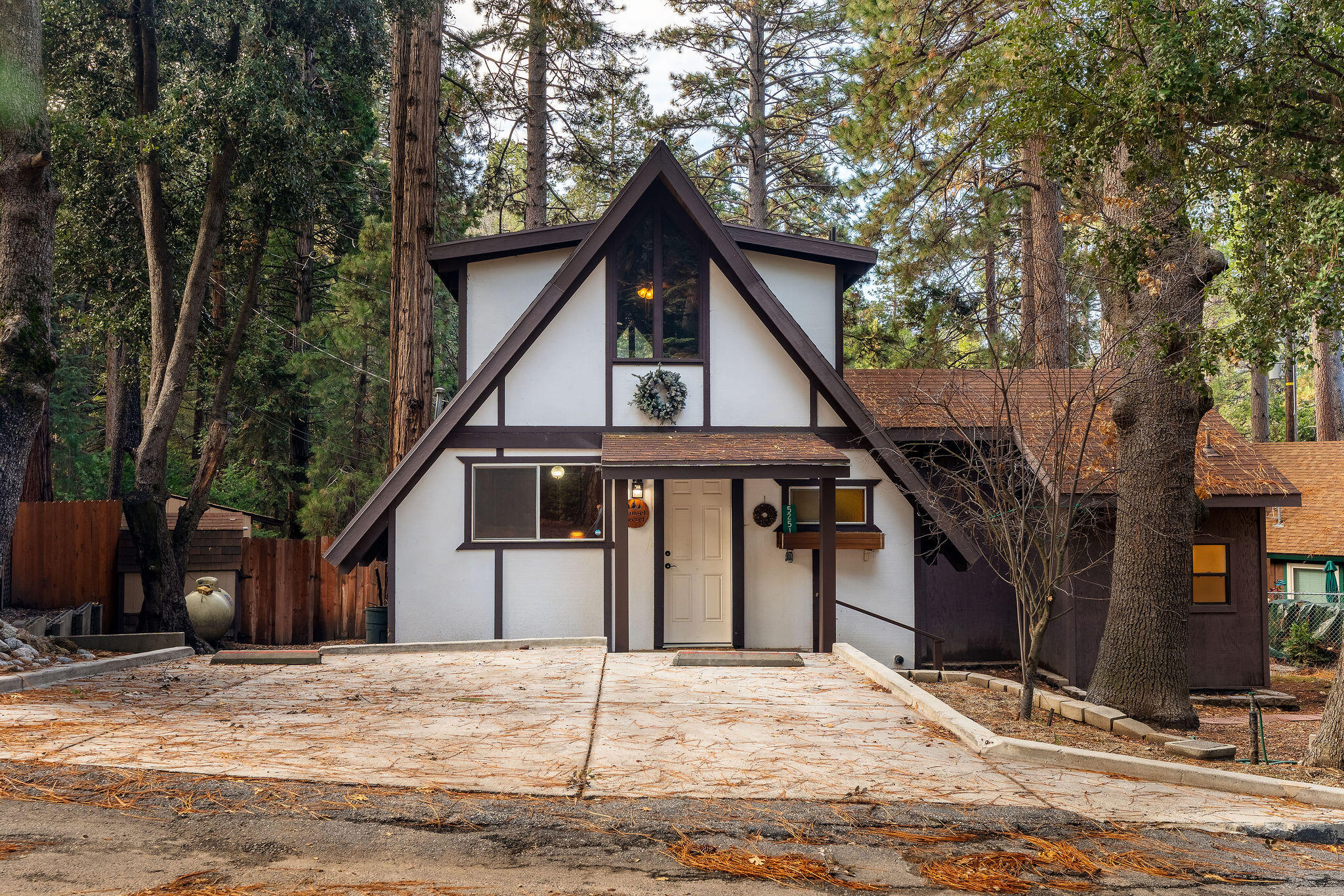 52515 Sunset Drive Idyllwild, CA 92549 - Photo 2 of 42 a front view of a house with a yard and garage