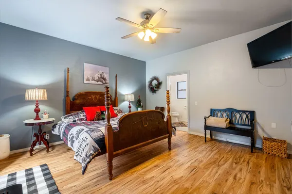 a bedroom with a bed and a chandelier