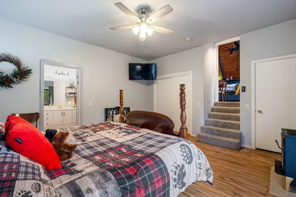 a bedroom with a bed and a chandelier