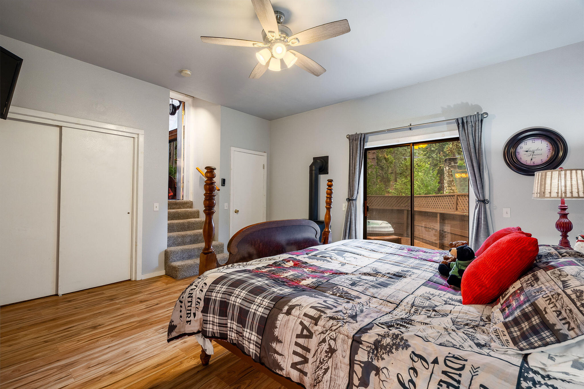 52515 Sunset Drive Idyllwild, CA 92549 - Photo 24 of 42 a bedroom with a bed and a chandelier