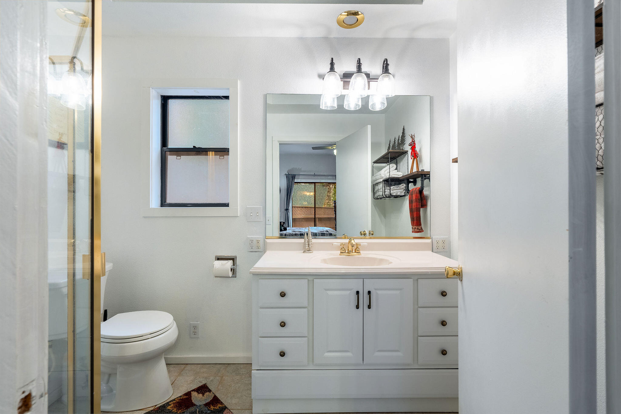 52515 Sunset Drive Idyllwild, CA 92549 - Photo 25 of 42 a bathroom with a sink a toilet and mirror