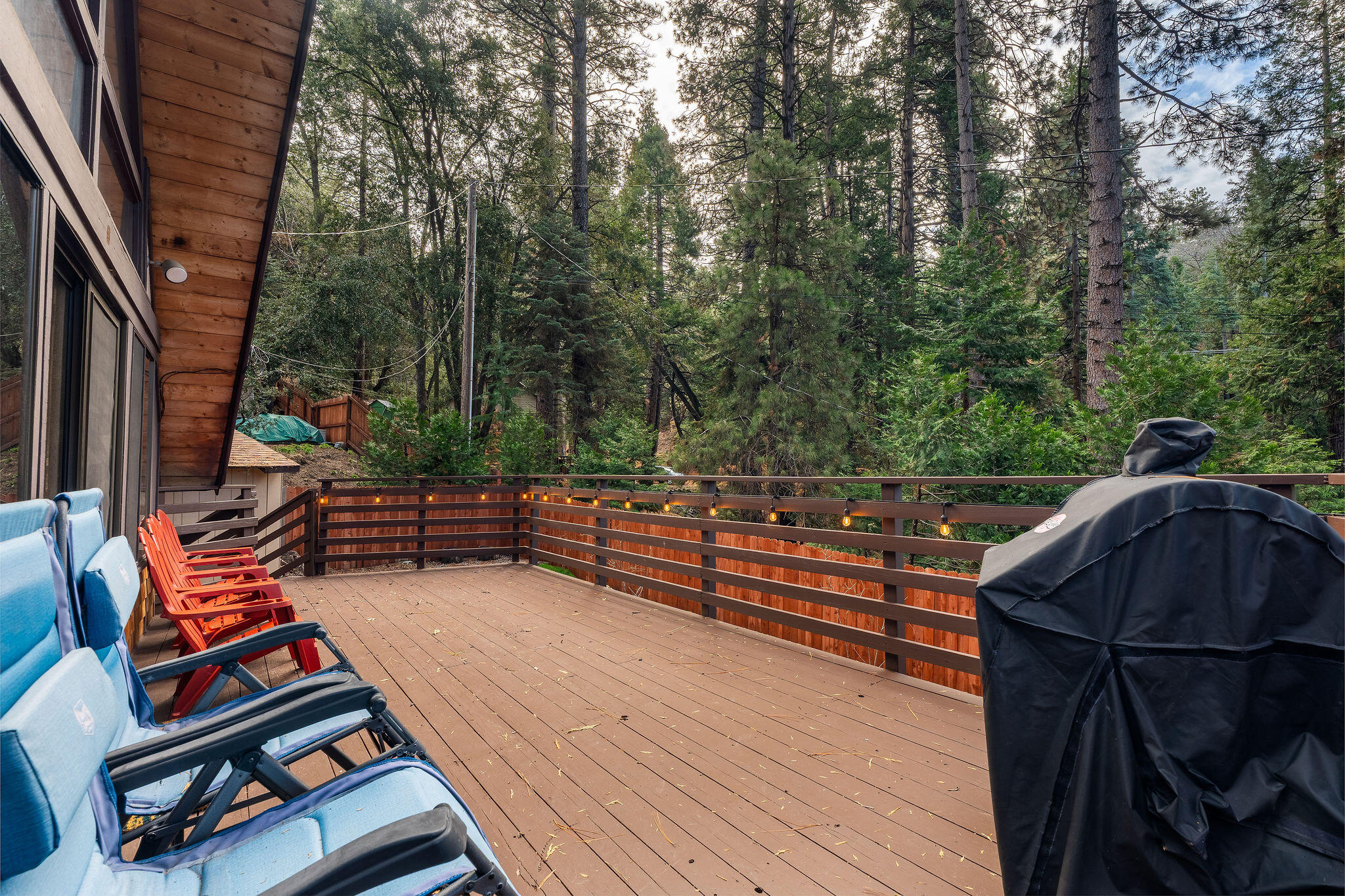 52515 Sunset Drive Idyllwild, CA 92549 - Photo 30 of 42 a backyard of a house with wooden floor and outdoor seating