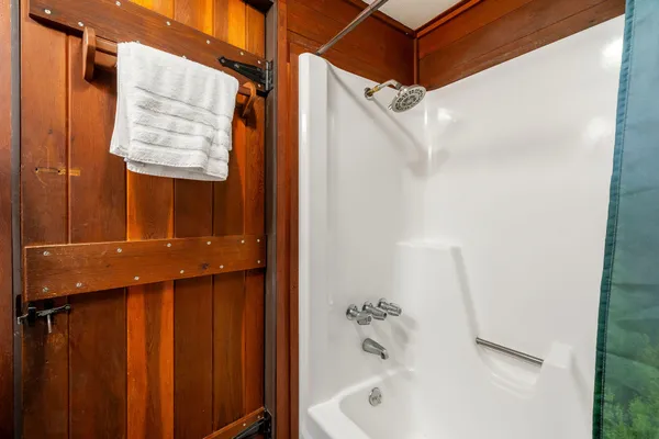 a bathroom with a bathtub and shower
