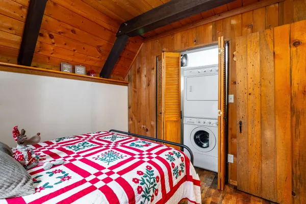 a bedroom with a bed and a chandelier