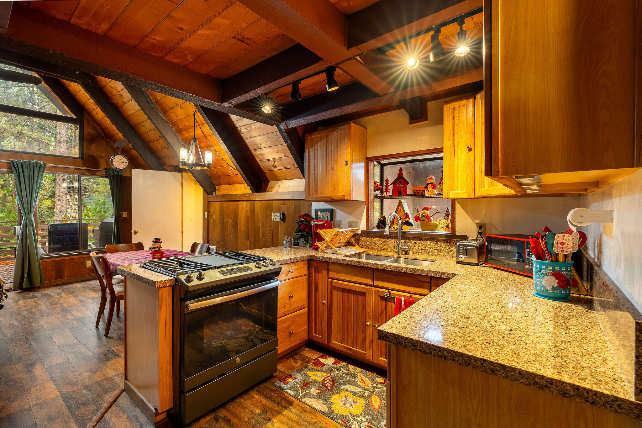 52515 Sunset Drive Idyllwild, CA 92549 - Photo 9 of 42 a kitchen with stainless steel appliances granite countertop a stove a sink and a microwave