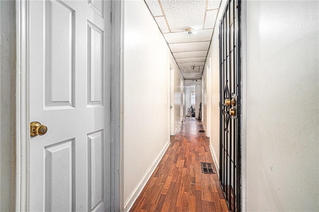 56 Ormond Street Southeast Atlanta, GA 30315 - Photo 3 of 15 a view of a hallway with wooden floor and staircase