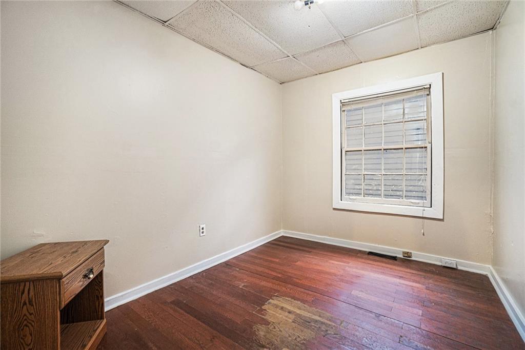56 Ormond Street Southeast Atlanta, GA 30315 - Photo 4 of 15 wooden floor in an empty room with a window