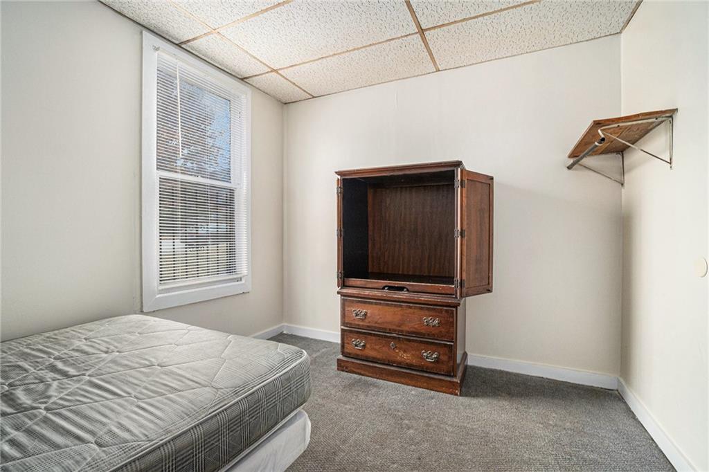 56 Ormond Street Southeast Atlanta, GA 30315 - Photo 9 of 15 a bedroom with a bed and a flat screen tv