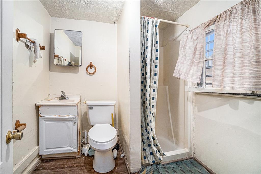 56 Ormond Street Southeast Atlanta, GA 30315 - Photo 10 of 15 a bathroom with a toilet and a shower