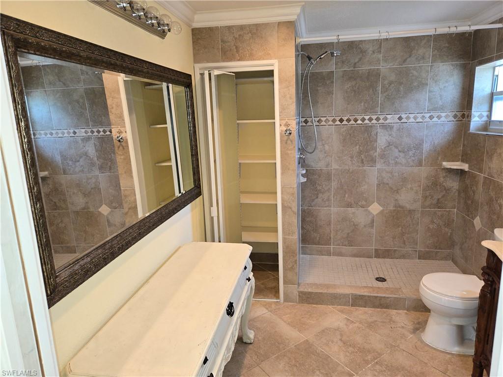 639 Pompano Drive Naples, FL 34110 - Photo 13 of 39 a bathroom with a bathtub and a shower