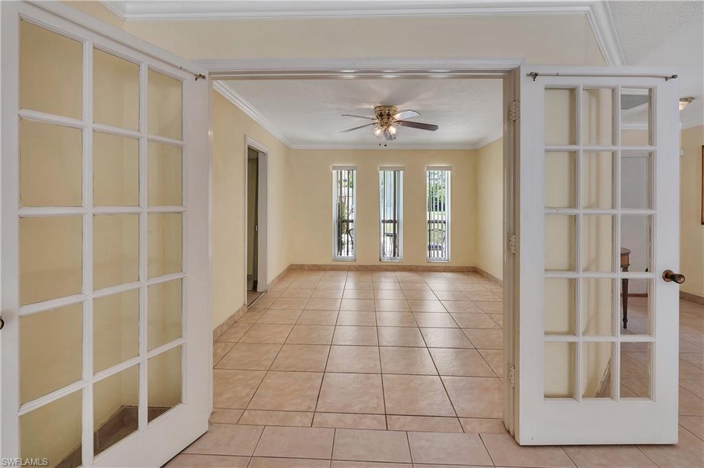 639 Pompano Drive Naples, FL 34110 - Photo 18 of 39 a view of a hallway with wooden floor and a large window
