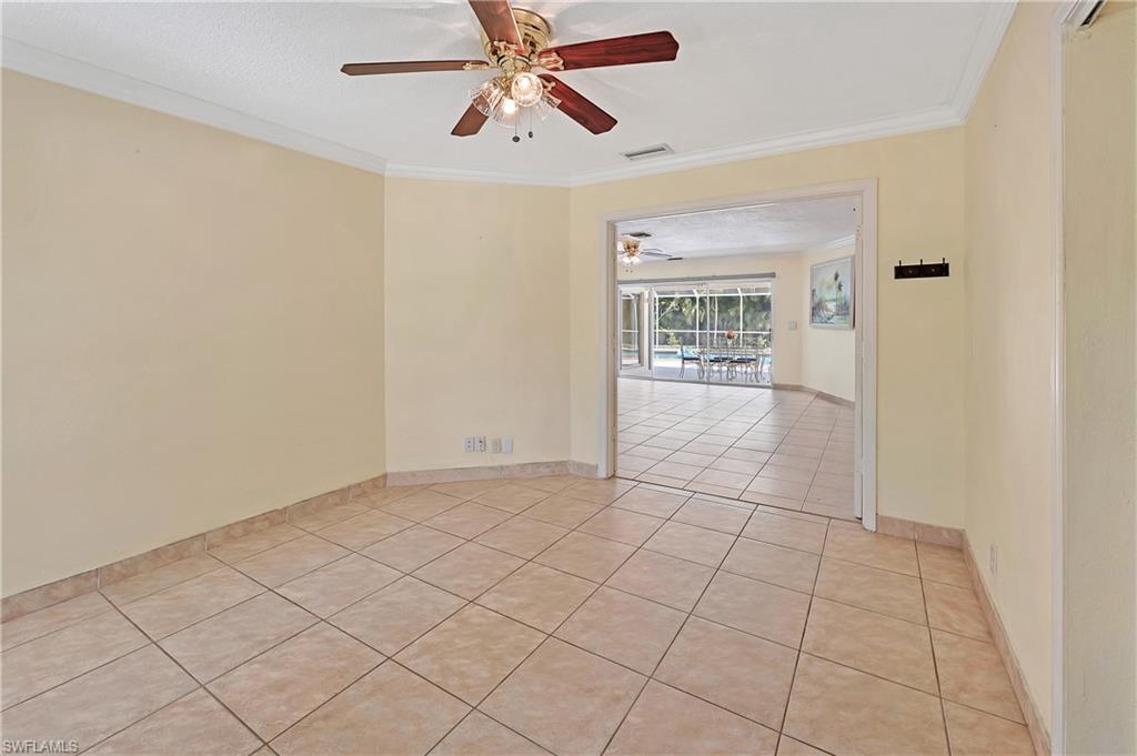 639 Pompano Drive Naples, FL 34110 - Photo 21 of 39 a view of an empty room and window with a ceiling fan