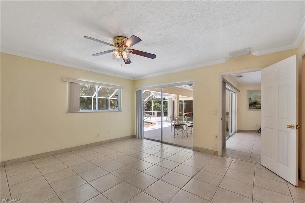 639 Pompano Drive Naples, FL 34110 - Photo 27 of 39 a view of a livingroom with a chandelier fan and windows