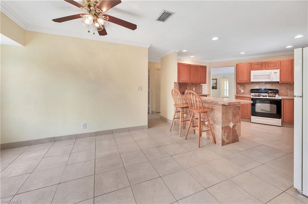 639 Pompano Drive Naples, FL 34110 - Photo 37 of 39 a view of a dining room with furniture