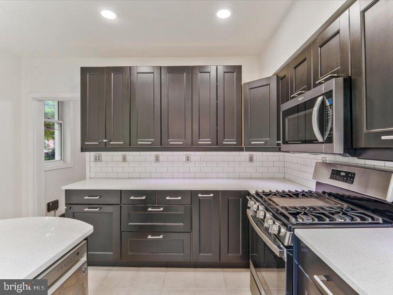 1200 D Street Northeast Washington, DC 20002 - Photo 12 of 47 Sleek modern kitchen with dark cabinetry.
