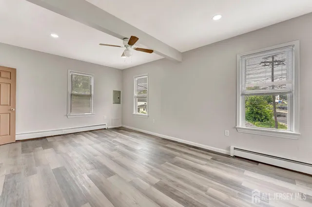 wooden floor in an empty room with a window