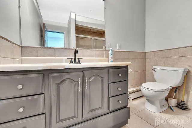 a bathroom with a toilet sink and mirror
