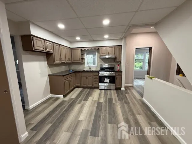 a kitchen with stainless steel appliances a sink stove and refrigerator