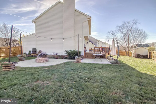 a view of a house with a yard and sitting area