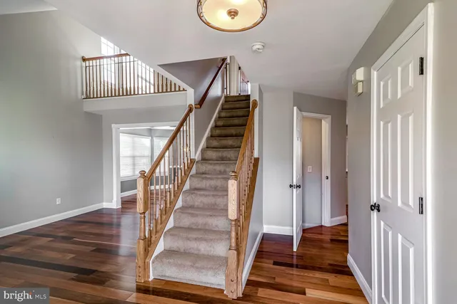 a view of entryway and hall with wooden floor