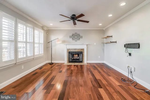 a view of an empty room with a fireplace and a window