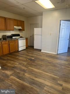 21614 Great Mills Road, Unit 104 Lexington Park, MD 20653 - Photo 5 of 17 a kitchen with granite countertop a stove a sink and a refrigerator