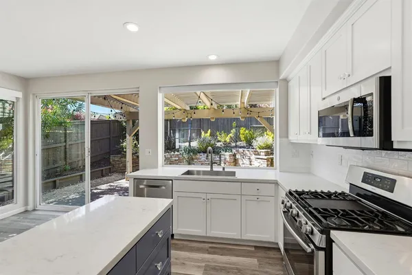 a kitchen that has a sink and a stove